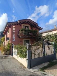 un bâtiment rose avec une porte devant lui dans l'établissement la bottega del fabbro affitto breve, à Contigliano