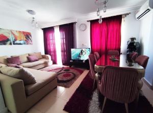 a living room with a couch and a table with a tv at Madinty Modern 2 rooms apartment at Madinty city for families only مدينتي in Madinaty