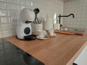 a kitchen counter with a coffee maker and cups on it at Sun coast house in Saulkrasti