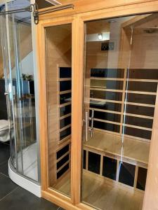a wooden cabinet with glass doors in a room at Chalet Bellevue Murau in Murau