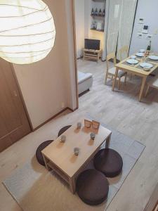 a living room with a table and some chairs at R House 川越 in Kawagoe
