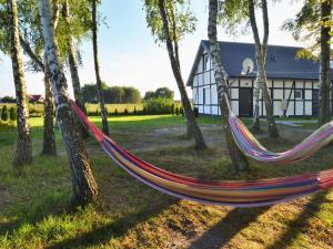 a hammock in a yard in front of a house at Two-story holiday house for 5 people, Jaroslawiec in Jarosławiec