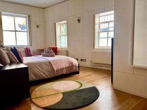 1 dormitorio con cama y alfombra en Shoreditch Private Studio, en Londres
