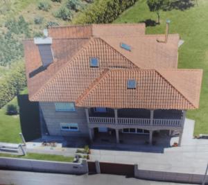 an aerial view of a house with a roof at Os Cabaleiros in Mos