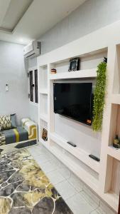 a living room with a flat screen tv on a wall at Ace Appartement Meublé in Nouakchott