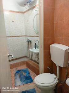 a bathroom with a toilet and a sink at Central Sophisticated Studio Pyrgos near Olympia in Pyrgos