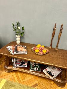 a table with a bowl of fruit on top of it at K-Apartment in Rīga
