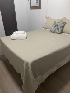 a large bed in a room with at Apartamento 03 br 290 restaurante Le Sorelle in Rosário do Sul