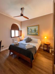 a bedroom with a bed and a ceiling fan at Convento Boutique Hotel in Susa +65 photos
