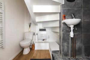 a bathroom with a toilet and a sink at Studio 63 in Roissy-en-Brie