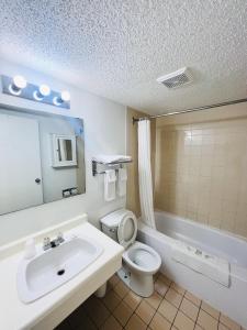 a bathroom with a sink and a toilet at Midtown Inn in Saskatoon