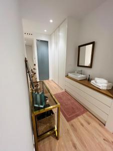 a bathroom with a sink and a mirror at ESPOLON LUXURY 10 in Logroño