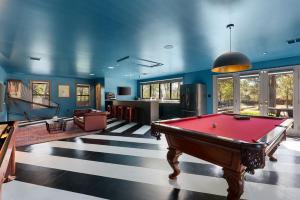 a pool table in a room with blue walls at Hot Tub + Fire Pit + Pool + Game Room ~ Guesthouse in Manor
