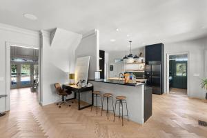 a kitchen with a island and bar stools in it at Hot Tub + Fire Pit + Pool + Game Room ~ Guesthouse in Manor