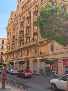 a large building with cars parked in front of it at Philo Hotel in Cairo