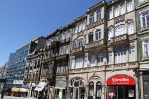 a large building on a street in a city at Home At Porto - Bolhão Apartments in Porto