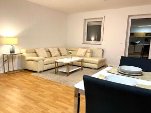 sala de estar con sofá y mesa en Moderne Ferienwohnung in Leimen mit Balkon, WeHome Komfort, en Leimen