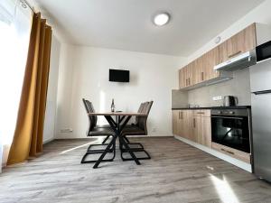 a kitchen with a table and chairs in a room at Sky Apartments 505 in Pilsen