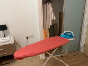 a red stretcher in a room next to a door at North Acton Flat in London