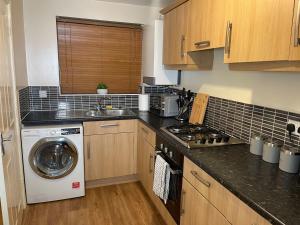 a kitchen with a washing machine and a washer at Entire 2BR Cosy Home Thornaby in Thornaby on Tees