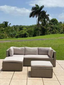 a couch and ottoman sitting on a patio at Apartamento El Secreto in Canovanas