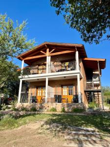 a large house with a wrap around porch at Mirador del Valle in Mina Clavero