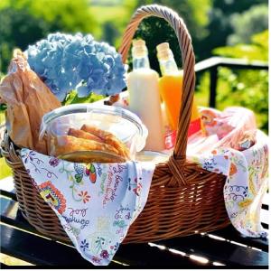 a picnic basket with food and drinks on a table at Quinta do Olival in Arcos de Valdevez
