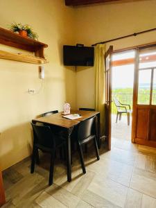 a dining room with a table and chairs and a television at Mirador del Valle in Mina Clavero +17 photos