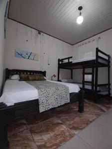 a bedroom with two bunk beds in a room at Salamandra Costa Rica in Jiménez