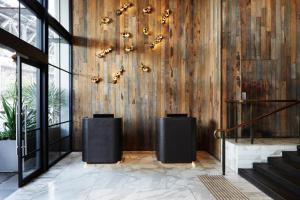 a lobby with a wooden wall with a chandelier at Pier One Sydney Harbour, Autograph Collection in Sydney