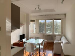 a living room with a glass table and a couch at Casa Giulia in Santarcangelo di Romagna