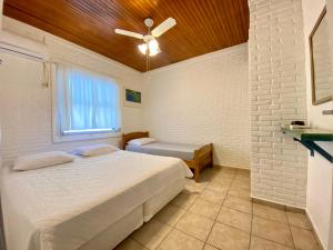 a bedroom with a bed and a ceiling fan at Casa Azul in São Sebastião