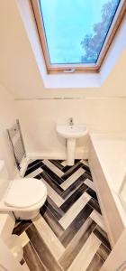 a bathroom with a white toilet and a sink at 9 Guest 7 Beds Lovely House in Rossendale in Newchurch