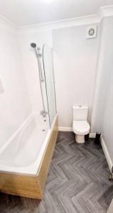 a bathroom with a shower and a toilet at 9 Guest 7 Beds Lovely House in Rossendale in Newchurch