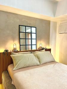 a bedroom with a large bed with a window at Avida Studio unit in Davao City