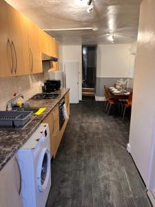 a kitchen with a washing machine in the middle of it at A little slice of London in London