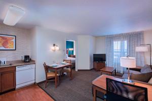 a living room with a kitchen and a living room with a table at Residence Inn Columbia in Columbia