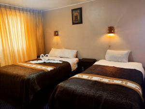 クスコにあるSQ Hotel del Incaのホテルルーム ベッド2台付
