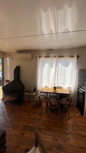 a living room with a table and a piano at Casa en alquiler El Detalle Punta Negra in Punta Colorada