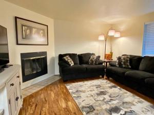 a living room with a couch and a fireplace at Hidden Gem in SE Boise with hot tub and wood burning fireplace in Boise
