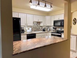 a kitchen with white cabinets and a granite counter top at Hidden Gem 2bed 2bath SE Boise community pool in Boise
