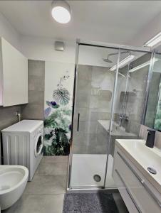 a bathroom with a shower and a toilet and a sink at Eddie's Luxury Apartments in Gliwice