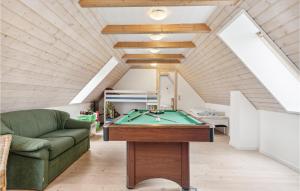 a living room with a pool table and a couch at 3 Bedroom Lovely Home In Bredebro in Bredebro