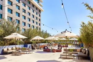 a patio with chairs and umbrellas in front of a building at JW Marriott, Anaheim Resort in Anaheim