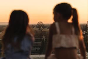 two women looking out at the ferris wheel at sunset at JW Marriott, Anaheim Resort in Anaheim