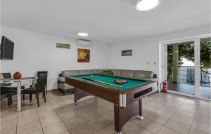 a living room with a pool table in it at Amazing Home In Makarska With 9 Bedrooms, Wifi And Outdoor Swimming Pool in Makarska