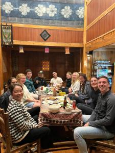 a group of people sitting around a table at Mekhoo & Zizi Sapa Homestay in Sa Pa