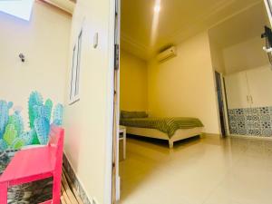 a room with a bed in the corner of a room at Homestay BONO Mũi Né in Phan Thiet