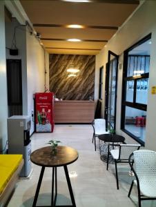 a restaurant with two tables and chairs in a room at Phoenix Guest House in Surabaya