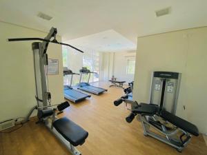 a gym with a row of treadmills and machines at 8 Spatial Condo in Davao City